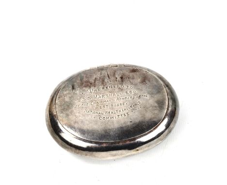 A George V oval silver tobacco box, with squeeze action lid and gilt interior, by Stokes & Ireland Ltd, hallmarks Chester 191