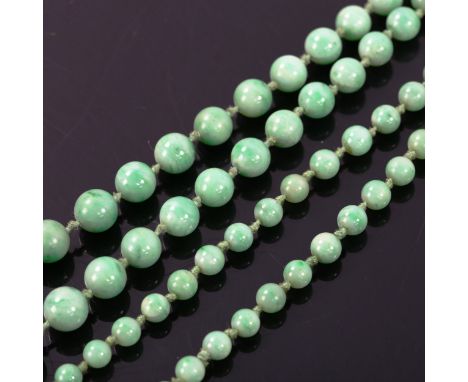 A single-strand graduated jade bead necklace, individually knotted, bead diameters 8.7mm - 4.5mm, necklace length 86cm, 51.1g
