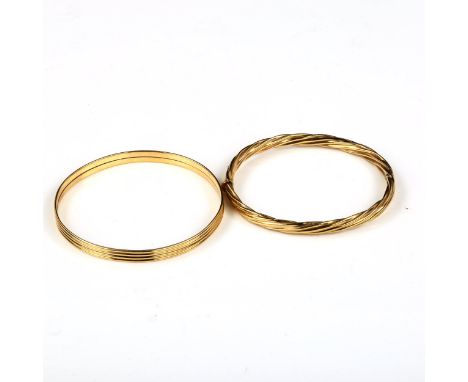 A 9ct gold slave bangle, band width 5.7mm, internal diameter 6.5cm, 13g, and an unmarked yellow metal twisted hinged bangle, 
