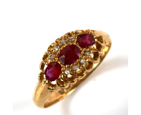 An early 20th century 18ct gold ruby and diamond cluster ring, set with oval mixed-cut ruby and rose-cut diamonds, hallmarks 