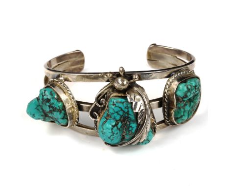 A Native American Navajo sterling silver and turquoise torque bangle, band width 34mm, internal measurement 6cm x 4.5cm, 63.8