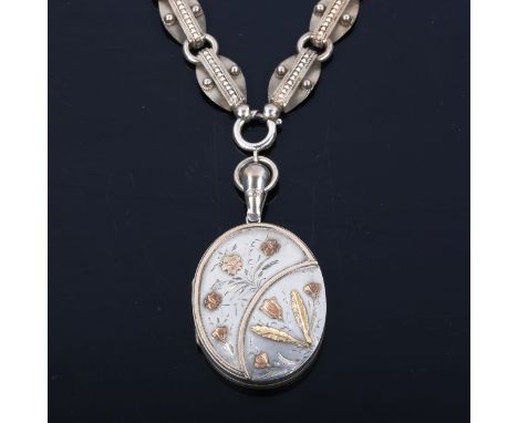 A Victorian sterling silver photo locket pendant necklace, with applied gold floral decoration, on fancy link chain, pendant 
