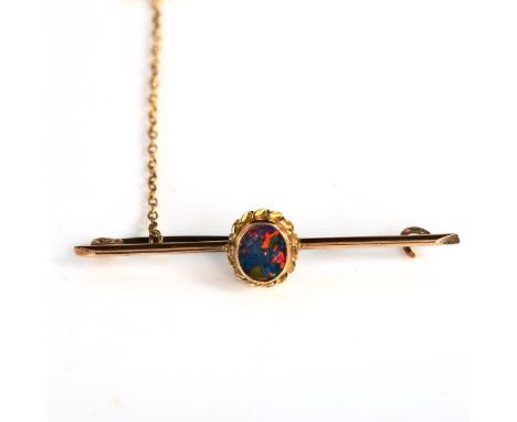 An unmarked gold black opal doublet bar brooch, length 43.4mm, 1.9gNo damage or repairs, settings lightly abraded, brooch fit