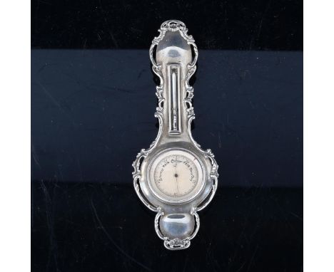 An unusual miniature silver-cased banjo-shaped barometer and thermometer, circa 1900, with cast surround, indistinct hallmark