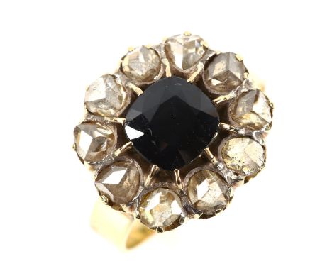 An 18ct gold sapphire and diamond cluster ring, set with oval cushion-cut sapphire and rose-cut diamonds, setting height 16.3
