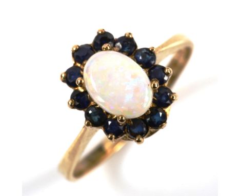 A 9ct gold opal and sapphire oval cluster ring, set with oval cabochon opal and round-cut sapphire, setting height 11.4mm, si