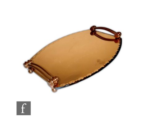 Unknown - An Art Deco tray of convex form, with scalloped edge and arched handles, raised to four ball feet, all in a peach m