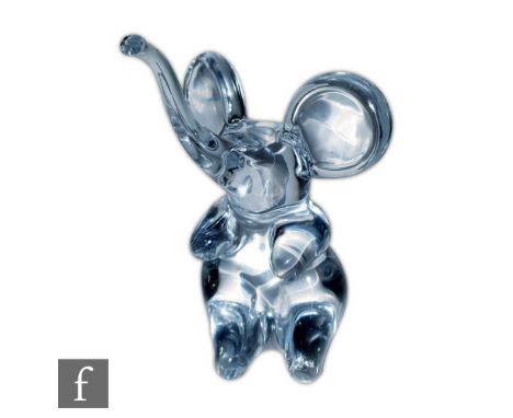 Daum - A contemporary clear crystal figure of a seated elephant with trunk raised, signed to the lower edge of the body, heig