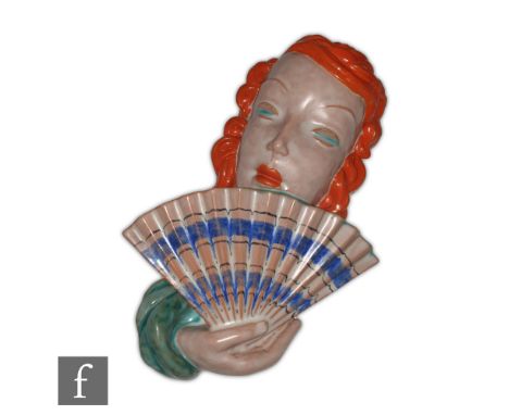 Rudolf Knorlein - Goldscheider - A 1930s Art Deco wall mask modelled as a lady with orange wavy hair holding a blue patterned