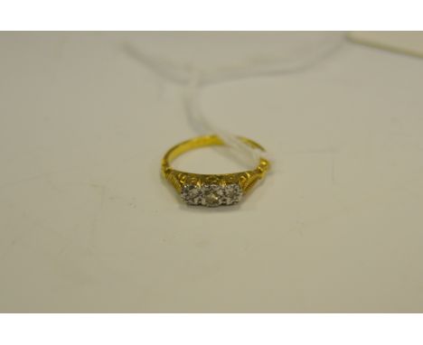 A diamond chip three stone ring, 18ct gold shank