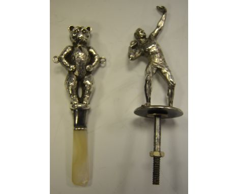 An early 20th Century silver child's teddy teather, hallmarked mother of pearl; a GSM plated mascot, cast as an athlete, c 19
