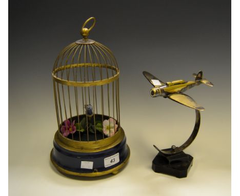 A continental automaton Bird in a cage (faults); a brass model of a Spitfire mounted on a stepped square base (2) 
