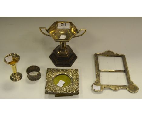 A silver shaped rectangular photograph frame, London 1905;  another, square;  a two handed octagonal trophy, Sheffield 1949; 