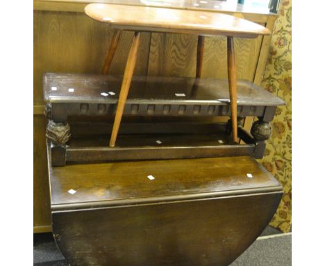 An  Ercol coffee table; an ebonised coffee table, carved supports, fluted to frieze; an oak foldable desk c 1930; an oak gate