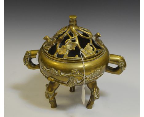 A 19th century Chinese brass tripod censer and cover, cast with blossoming prunus, seal mark