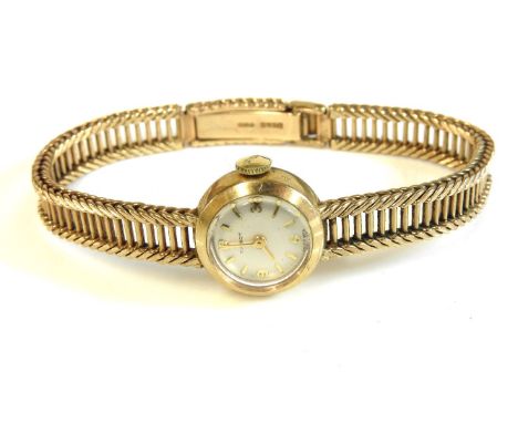 A 9ct gold ladies Tissot mechanical bracelet watch, with silvered dial, baton and Arabic numerals, 20.30g