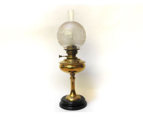 A brass oil lamp, with glass shade and funnel