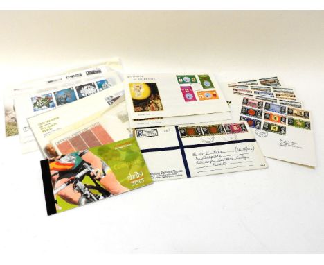 A suitcase containing a large quantity of Queen Elizabeth II Guernsey stamps, first day cover presentation packs etc