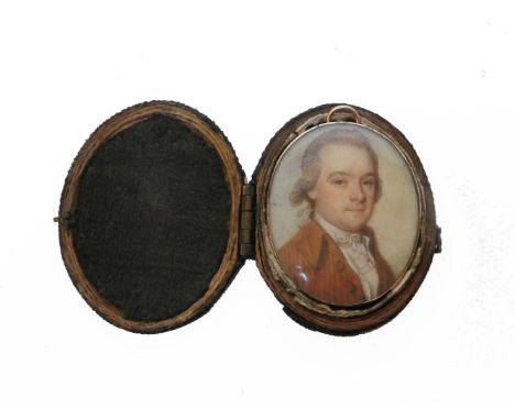 PORTRAIT OF A GENTLEMAN WEARING A BROWN COAT,oval on iron, late 18th century, in a 15ct mount with ring suspension, in a hing