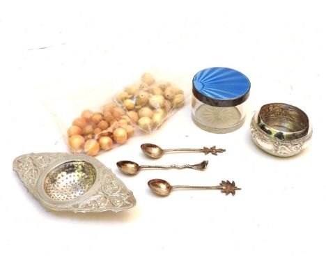 Two sets of 19th century ivory beads, a circular blue enamel and silver pot, an Indian silver strainer and three spoons