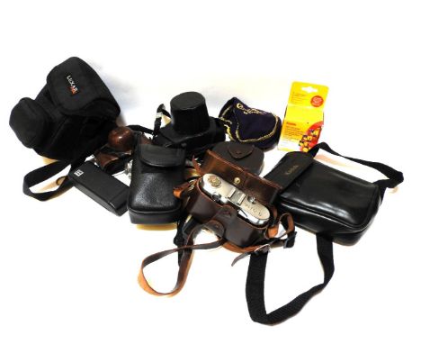 A collection of cameras and light meters, including a Voigtlander Vito B