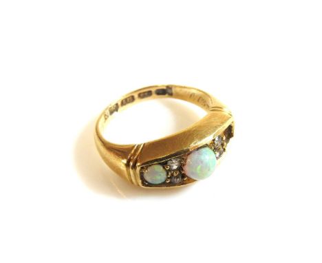 An 18ct gold three stone opal boat shaped ring, set with pairs of diamond points, (one opal deficient)