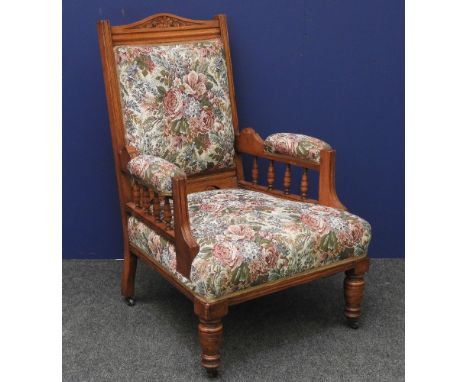 A late Victorian oak armchair, with tapestry upholstered back and seat