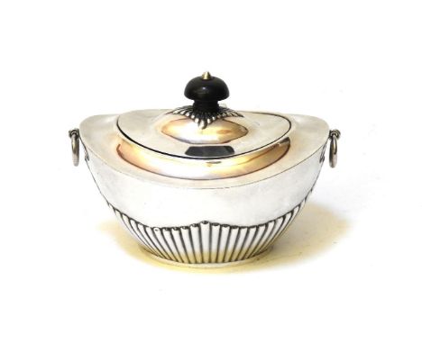 A silver tea caddy of ovoid form, hallmarked, with half reeded body