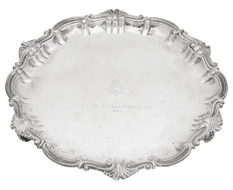 A late Victorian silver salverLondon, 1895, Thomas Bradbury &amp; Sons of circular form with raised scroll border, on bracket