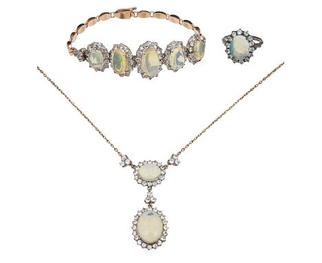 An opal parurecomprising a two stone drop pendant necklace to the fancy link back chain, a graduated five stone and oval link