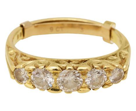 An 18ct gold diamond five stone ringround brilliant-cut diamonds, of graduating form, set to a pierced scrolling mount, to a 