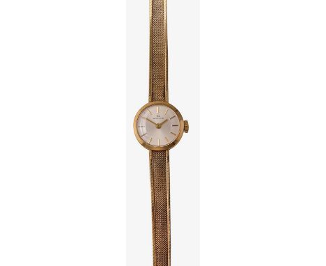 A Garrard manual wind 9ct gold ladies bracelet wristwatchthe silvered round dial with baton numerals, and a mesh gold bracele