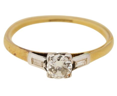 A diamond solitaire ringcentral round brilliant cut diamond, claw set, with baguette-cut diamond set shoulders, to a plain sh