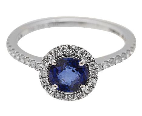 A sapphire and diamond halo ring by Mappin &amp; Webbcentral round brilliant cut sapphire, claw-set above a diamond mount, to