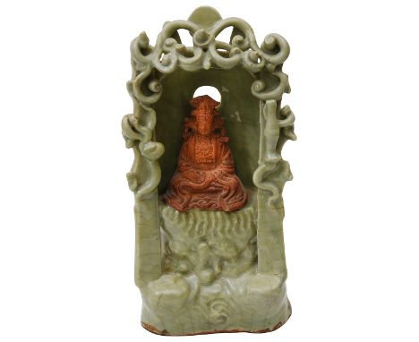 A Chinese Longquan celadon glazed and biscuit Guanyin shrine probably Ming or later the shrine is modelled with the figure of