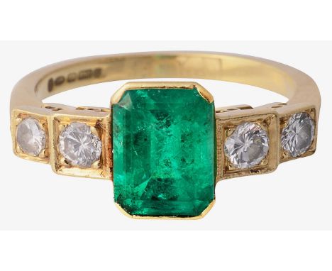 An 18ct emerald and diamond five stone ring the central rectangular cut-cornered emerald bezel set gallery, the stepped two s