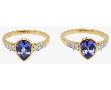 A pair of 18ct gold, tanzanite and diamond set ringsfeaturing a central pear cut sapphire, collet set between two round brill