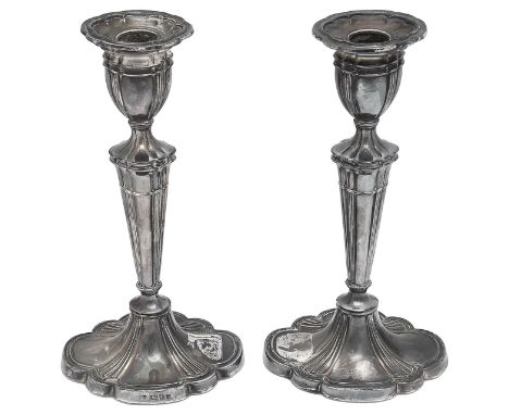 A pair of Elizabeth II silver candlesticksLondon, 1973, D J Silver Repairsof shaped oval outline on tapering stems and weight