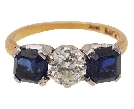 A sapphire and diamond three stone ringthe central old brilliant-cut diamond set to either side with a rectangular cut-corner