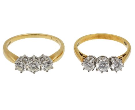 Two diamond ringseach set with three brilliant-cut diamonds to the hallmarked 18ct setting (2)ring sizes O - R, combined weig