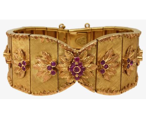 A wide articulated bracelet with ruby detailthe graduated textured rectangular panels applied with foliate decoration with ru