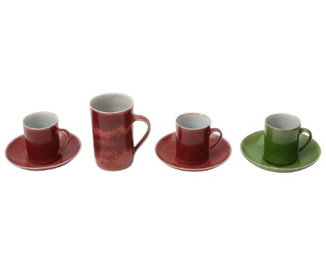 Rupert Spira (British b.1960) Three studio pottery stoneware coffee cups and saucers and a mugtwo copper red glazed, one gree