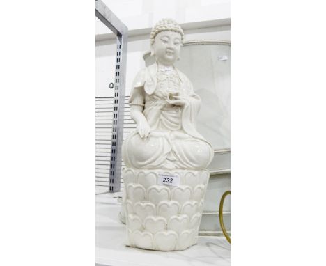 Oriental blanc de chine figure of a Buddha seated on lotus plants, two Oriental-style lamps and a carved wooden table lamp wi