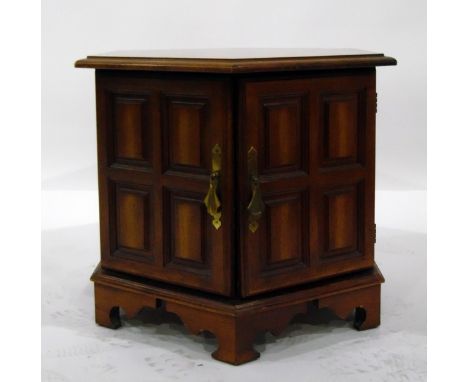 Octagonal top table with panelled cupboards below, on bracket feet, width 60cm 