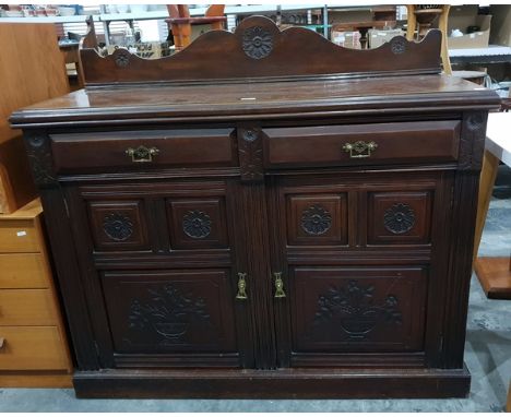 Late Victorian mahogany side cupboard with carved shaped splashback, two frieze drawers, with a pair of carved panel doors be