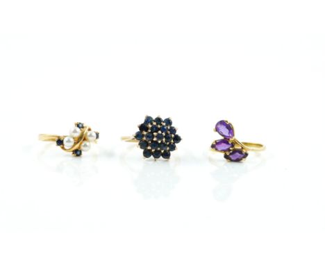 A 9CT GOLD AND SAPPHIRE HEXAGONAL CLUSTER RING AND TWO FURTHER GOLD AND GEM SET RINGS (3)The sapphire cluster ring mounted wi