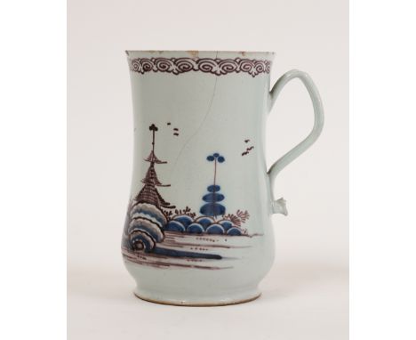 AN ENGLISH DELFTWARE MUGMid 18th century
Of slender baluster form with ribbed handle, painted in blue and manganese with a ch