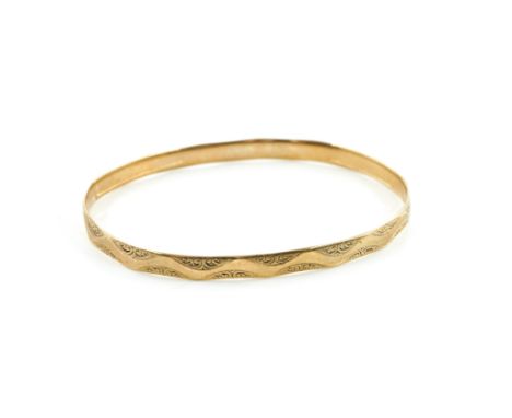 A 9CT GOLD BANGLEOf oval form, with engraved decoration, Birmingham 1925, weight 17.8 gms