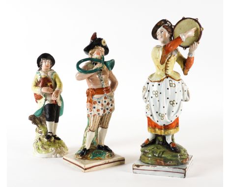 THREE STAFFORDSHIRE PEARLWARE FIGURES OF MUSICIANS (3)Early 19th century
Comprising; a young man playing the french horn and 
