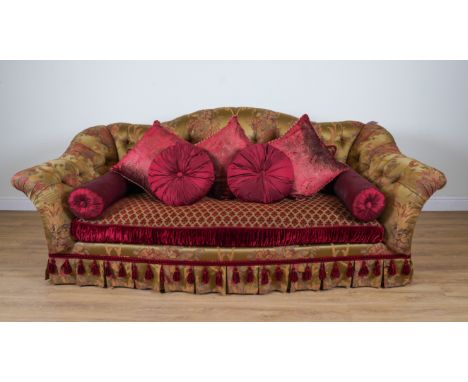 PROVASI: A LARGE GREEN/GOLD FLORAL SILK UPHOLSTERED BUTTON BACK SOFAOf serpentine outline, on turned gilt supports, 265cm wid
